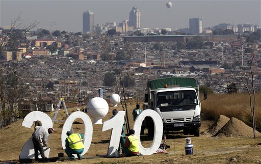 Municipal workers paint the 2010 structure at the Alexandra township in Johannesburg, South Africa, Tuesday June 8, 2010, as they prepare for the soccer World Cup, that gets underway on June 11, 2010. (AP Photo/Themba Hadebe)