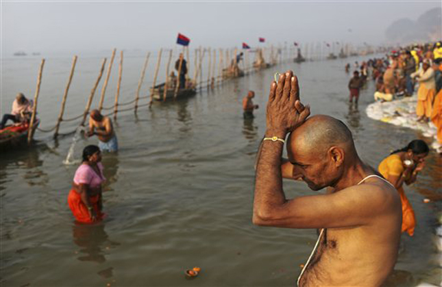 Indian Hindu pilgrims bathe at Sangam, the confluence of the rivers Ganges, Yamuna and mythical Saraswati, ahead of the Maha Kumbh Mela in Allahabad, India, Sunday Jan. 13, 2013. Millions of Hindu pilgrims are expected to take part in the large religious congregation of a period of over a month on the banks of Sangam during the Maha Kumbh Mela in January 2013, which falls every 12th year. (AP Photo/Kevin Frayer)