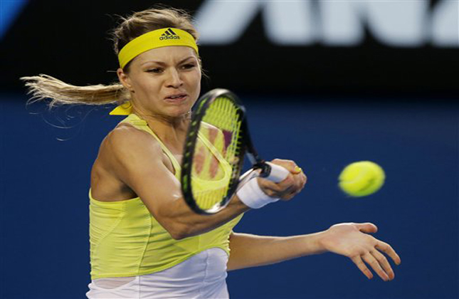 Russia's Maria Kirilenko hits a return to Serena Williams of the US during their fourth round match at the Australian Open tennis championship in Melbourne, Australia, Monday, Jan. 21, 2013. (AP Photo/Dita Alangkara)