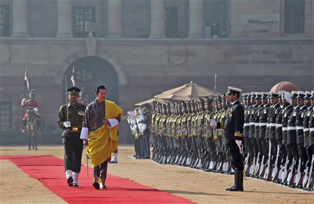 Bhutan's King Jigme Khesar Namgyel Wangchuck, center, inspects a guard of honor during a ceremonial reception in New Delhi, India, Friday, Jan. 25, 2013. Wangchuck will be the chief guest on Republic Day celebrated annually on Jan. 26. (AP Photo/Manish Swarup)