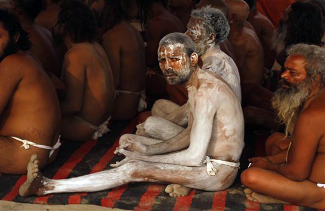 Hindu holy men of the Juna Akhara sect participate in rituals that are believed to rid them of all ties in this life and dedicate themselves to serving God as a 'Naga' or naked holy men, at Sangam, the confluence of the Ganges and Yamuna River during the Maha Kumbh festival in Allahabad, India, Wednesday, Feb. 6, 2013. The significance of nakedness is that they will not have any worldly ties to material belongings, even something as simple as clothes. This ritual that transforms selected holy men to Naga can only be done at the Kumbh festival. (AP Photo/ Rajesh Kumar Singh)