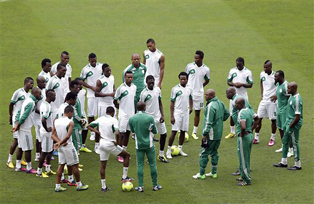 Nigeria national soccer team players huddle up with coaches at the start of a pre match training session, at Moses Mabhida Stadium in Durban, South Africa, Tuesday, Feb. 5, 2013. Nigeria will face Mali Wednesday, Feb. 6, in their African Cup of Nations semifinal soccer match. (AP Photo/Rebecca Blackwell)