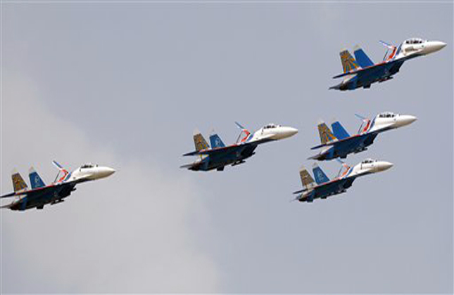The Russian Knights, the aerobatic team of the Russian Air Force, performs in their Sukhoi Su 27 and Su 27UB fighter aircraft on the third day of the Aero India 2013 at Yelahanka air base in Bangalore, India, Friday, Feb. 8, 2013. More than 600 aviation companies along with delegations from 78 countries are participating in the five day event that started Wednesday. (AP Photo/Aijaz Rahi)