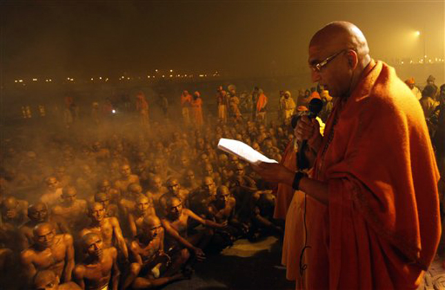 Swami Avdheshanand Giri, right, initiates Hindu holy men of the Juna Akhara during rituals that is believed to rid them of all ties in this life and dedicate themselves to serving God as a 'Naga' or naked holy men, at Sangam, the confluence of the Ganges and Yamuna River during the Maha Kumbh festival in Allahabad, India, early Thursday, Jan. 31, 2013. The significance of nakedness is that they will not have any worldly ties to material belongings, even something as simple as clothes. This ritual that transforms selected holy men to Naga can only be done at the Kumbh festival. (AP Photo/ Rajesh Kumar Singh)