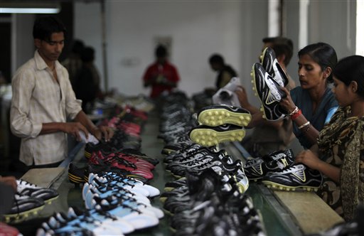 In this photo taken Thursday, June 10, 2010, workers arrange newly manufactured soccer shoes at a manufacturing unit on the outskirts of Jalandhar, India. A report by the International Labor Rights Forum (ILRF), just days ahead of the start of the World Cup soccer tournament, said that Asian workers who stitch nearly all the world's soccer balls have seen little improvement in lives dominated by poverty. After over a decade of promised reforms from the sporting goods industry, extensive use of child labor and debt bondage in the production of soccer balls continue in the two Indian villages of Jalandhar and Meerut, according to an earlier report by ILRF. (AP Photo/Altaf Qadri)