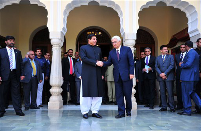 Indian Foreign Minister Salman Khurshid, right, shakes hands with Pakistan's Prime Minister Raja Pervaiz Ashraf in Jaipur, India, Saturday, March 9, 2013. Ashraf is in India on Saturday on a daylong private visit to the shrine of Sufi saint Moinuddin Chishti in the nearby town of Ajmer. Sufism is a more mystical form of Islam that is practiced in many parts of South Asia. (AP Photo)