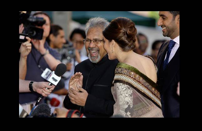 Indian director Mani Ratnam, centre left, reacts with Indian actress Aishwarya Rai Bachchan, on the red carpet for the World Premiere of the film Raaven, at the BFI, British Film Institute, in London, Wednesday, June 16, 2010. (AP Photo/Joel Ryan)