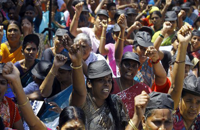 Indian Tamil women shout slogans during a protest against Sri Lanka's Sinhalese dominated government, which has been accused of abusing Tamils during the country's civil war, in Mumbai, India, Wednesday, March 20, 2013. The protesters demanded that India support the resolution that the United States proposes to introduce at the current United Nations Human Rights Council meeting urging a full accounting of what happened at the end of Sri Lanka's civil war. (AP Photo/Rafiq Maqbool)