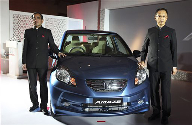 Honda Motor Company Managing Officer Yoshiyuki Matsumoto, left, and Honda Cars India Limited President and Chief Executive Officer Hironori Kanayama, pose for the media during the launch of Honda's new Amaze diesel engine car in New Delhi, India, Thursday, April 11, 2013. (AP Photo/Altaf Qadri)