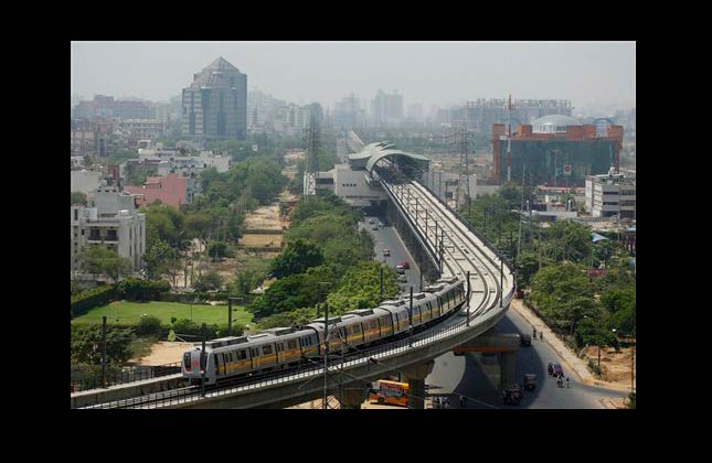 A metro train heads towards the IFFCO Chowk station of the Delhi Metro Rail in Gurgaon, India, Monday, June 21, 2010. The metro is the pride of the city of 14 million, where commuters were long forced to rely on rickshaws, motorcycles or smoke belching buses. (AP Photo/Gurinder Osan)