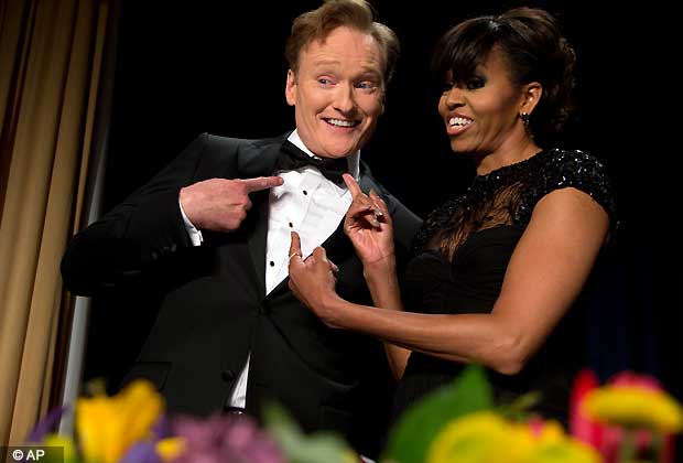 First lady Michelle Obama and late night television host and comedian Conan O'Brien gesture to his tie at the White House Correspondents' Association Dinner at the Washington Hilton Hotel, Saturday, April 27, 2013, in Washington.