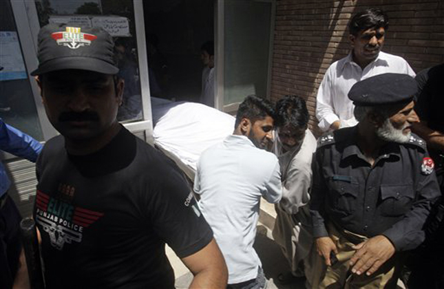 Pakistani hospital staff transfer the body of jailed Indian spy Sarabjit Singh after an autopsy at a local hospital in Lahore, Pakistan on Thursday, May 2, 2013. Indians expressed outrage at the Pakistan government Thursday over the death of a convicted Indian spy who had been attacked with a brick by two fellow inmates in a Pakistan prison, a development New Delhi said has damaged relations between the longtime rival nations. (AP Photo/K.M. Chaudary)