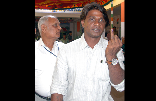 Actor Vijay and his father cast their votes during the Karnataka Assembly election, in Bangalore on Sunday 5th of May 2013. (Photo IANS)