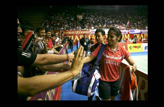 CORRECTS PHOTOGRAPHER'S NAME Saina Nehwal of India is greeted by supporters following her victory of the women's singles final over Sayaka Sato of Japan at the Indonesia Open Badminton Super Series, Sunday, June 27, 2010 at Istora Senayan in Jakarta, Indonesia. Nehwal won the match 21 19, 13 21, 21 11. (AP Photo/Achmad Ibrahim)