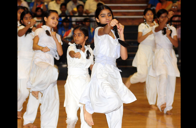 Girl students demonstrating martial art for self defence during a function organized by Delhi government Education Department at Thyagaraj Stadium in New Delhi on May 14, 2013. (Photo IANS)