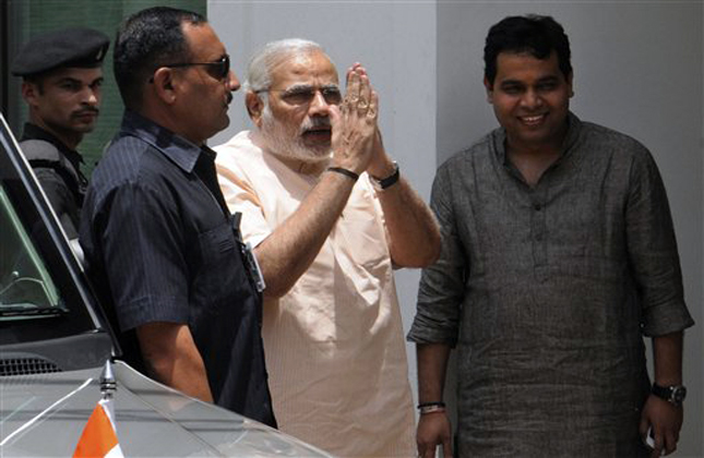 Gujarat state Chief Minister Narendra Modi, center, greets as he arrives to attend the Bharatiya Janata Party (BJP) Parliamentary board meeting in New Delhi, India, Tuesday, May 21, 2013. (AP Photo)