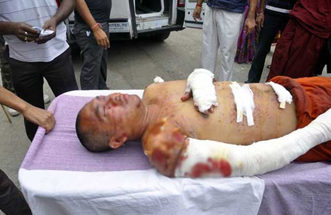 A Buddhist monk is carried on a stretcher for treatment after he was injured in an explosion in Bodhgaya, about 130 kilometers (80 miles) south of Patna, the capital of the eastern Indian state of Bihar, Sunday, July 7, 2013. A series of small blasts hit three Buddhist temples in eastern India early Sunday, injuring at least two people, police said. AP Photo