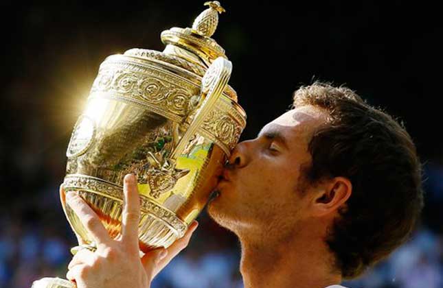 Andy Murray of Britain poses with the trophy after defeating Novak Djokovic of Serbia during the Men's singles final match at the All England Lawn Tennis Championships in Wimbledon, London, Sunday, July 7, 2013. AP Photo