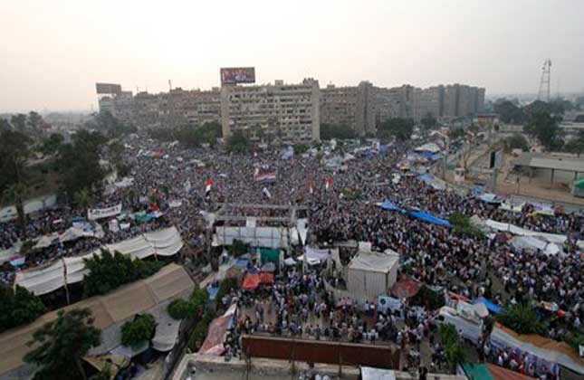 Supporters of the ousted President Mohammed Morsi shout slogans in Nasr City, asuburb of Cairo, Egypt, Monday, July 8, 2013. Egyptian soldiers and police opened fire on supporters of the ousted president early Monday in violence that left dozens of people killed, including one officer, outside a military building in Cairo where demonstrators had been holding a sit in, government officials and witnesses said. AP Photo