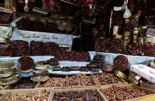 A Yemeni vendor selling dates sits on his shop at a market in Sanaa, Yemen, Tuesday July 2, 2013. With the holy month of Ramadan approaching, Muslim residents in Yemen prepare to welcome the holy month. Many of them visit markets to buy dates to use daily throughout the month. During the period of Ramadan, Muslims generally break their fast by eating dates and take on tremendous religious significance for them. AP Photo