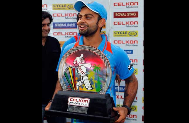 India's Virat Kohli holds the trophy after his team won the final match of the Tri Nation cricket series in Port of Spain, Trinidad, Thursday, July 11, 2013. India beat Sri Lanka by one wicket with two balls remaining. AP Photo