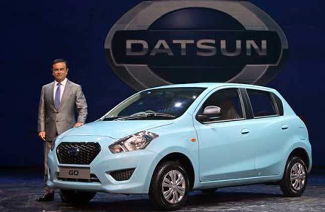 Nissan Motor Co. President and CEO Carlos Ghosn poses for the media with Datsun Go during its global launch in New Delhi, India, Monday, July 15, 2013. Nissan has introduced the first new Datsun model in more than three decades in the Indian capital. The company hopes bringing back the brand that built its U.S. business will fuel growth in emerging markets with a new generation of car buyers. The reimagined Datsun a five seat hatchback will go on sale in India next year for under 400,000 rupees (about $6,670). AP Photo