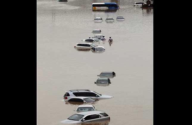 Vehicles are submerged in floodwater after a torrential rain hit the metro area in Seoul, South Korea, Monday, July 22, 2013. Heavy rain battered the central part of the Korean Peninsula, including Seoul, Monday, flooding homes and roads, according to police. AP Photo