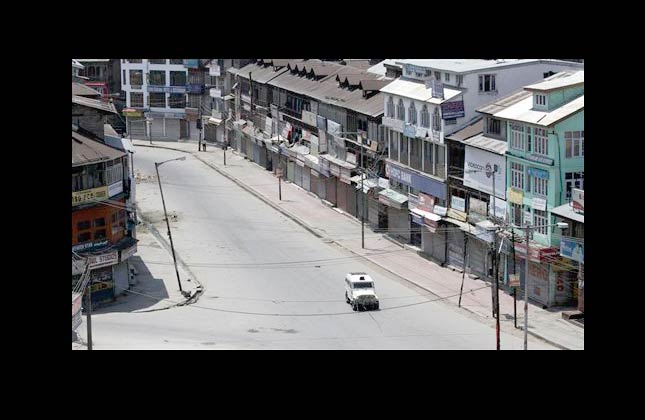 A police vehicle patrols a deserted street during curfew in Srinagar, India, Friday, July 2, 2010. Authorities on Friday extended an indefinite curfew to most parts of the Indian controlled portion of Kashmir and locked down its main city in an attempt to prevent a rally against Indian rule. (AP Photo/Mukhtar Khan)