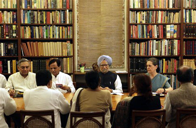 Indian Prime Minister Manmohan Singh, center, and Congress party president Sonia Gandhi, center right, attend a meeting of the Congress Working Committee, the party's highest decision making body in New Delhi, India, Tuesday, July 30, 2013. AP Photo
