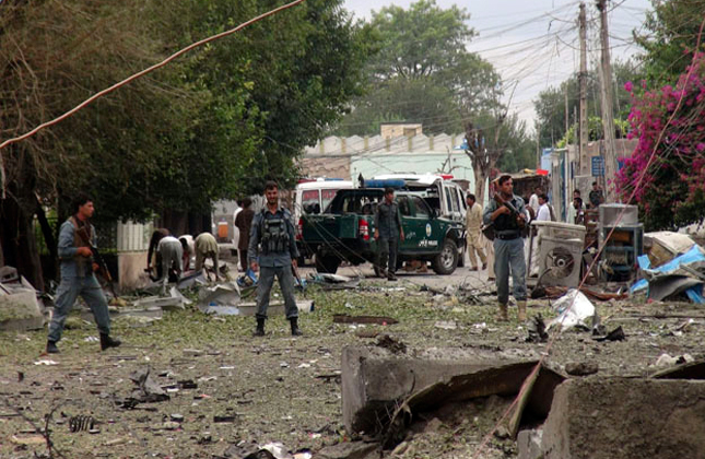 Security officials investigates the scene of an attack near the Indian consulate in the city of Jalalabad, Afghanistan, Saturday, 3, 2013. Three suicide attackers killed at least nine civilians, most of them children, in the botched attack Saturday on the Indian consulate in the eastern Afghan city near the border with Pakistan, security officials said. AP Photo