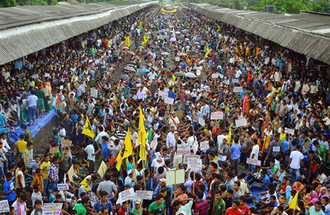 All Bodo Students Union and other Bodo organizations sit on railway tracks during the twelve hours railway blockade demanding separate state of Bodoland in Kokrajhar town in lower Assam, India, Friday, Aug. 2, 2013.(AP Photo)