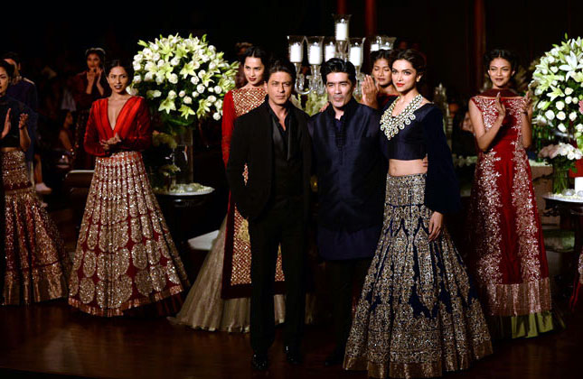 Shah Rukh Khan and Deepika walk the ramp for designer Manish Malhotra at the PCJ Delhi Couture Week, held in New Delhi on Sunday.