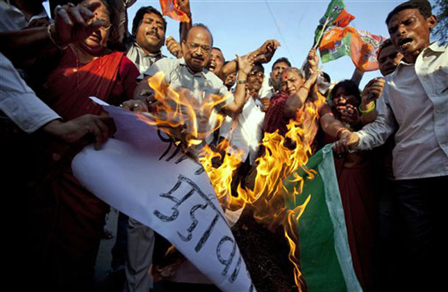 Activists of India's main opposition Bharatiya Janata Party (BJP) shout slogans and burn a representation flag of Pakistan during a protest against the death of five Indian army soldiers in cross border exchanges, in Allahabad, India, Tuesday, Aug. 6, 2013. (AP Photo)