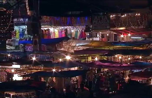 Markets illuminated on the eve of Eid as Indian Muslims gather for shopping.