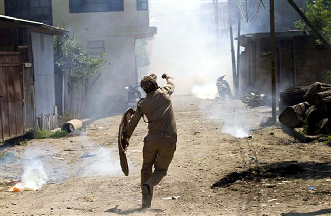Security personnel hurls back stones at protesters during a clash in Srinagar on Friday, Aug. 9. (AP Photo)