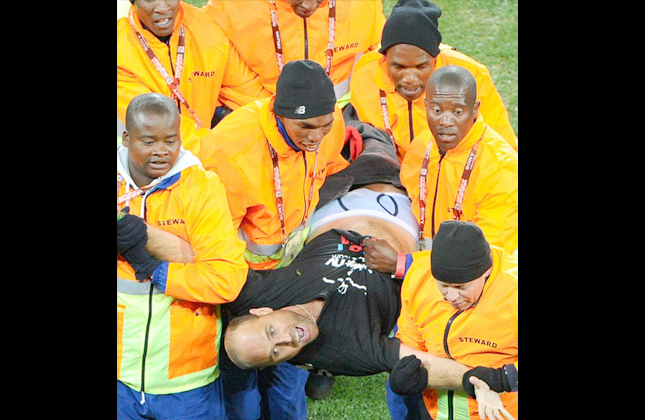 Facing jail Jump is carried from the Soccer City grounds and is charged by police