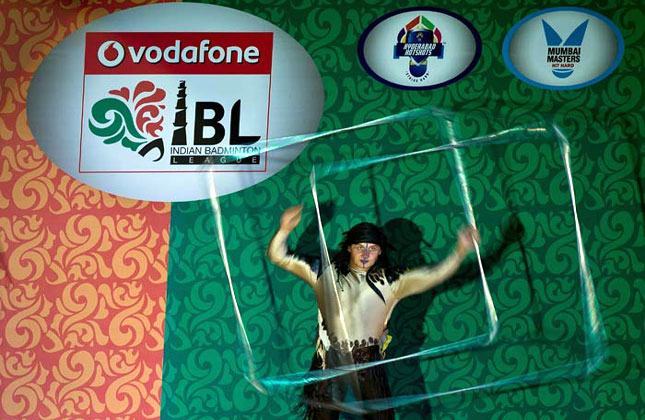 An acrobat performs during the opening ceremony of the Indian Badminton League (IBL) 2013 at the Siri Fort Sports Complex in New Delhi on August 14, 2013.