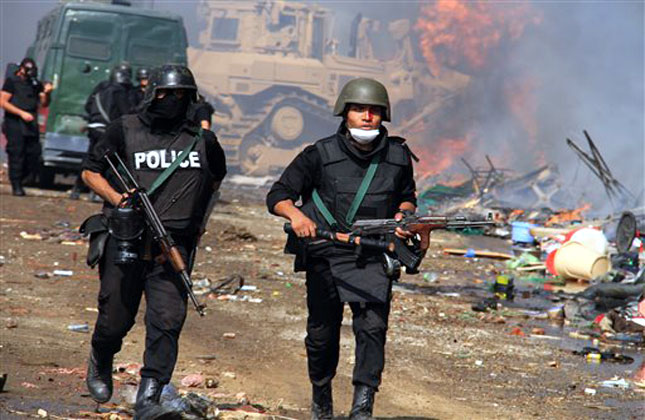 Egyptian security forces clear a sit in camp set up by supporters of ousted Islamist President Mohammed Morsi in Nasr City district, Cairo, Wednesday, Aug. 14, 2013. Egyptian security forces detain supporters of ousted Islamist President Mohammed Morsi as they clear a sit in camp set up near Cairo University in Cairo's Giza district, Wednesday, Aug. 14, 2013. (AP Photo)