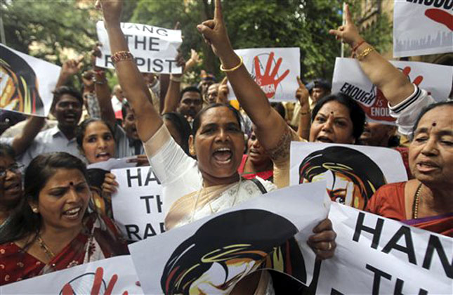 Indian activists hold placards as they protest against the gang rape of a 22 year old woman photojournalist in Mumbai India, Friday, Aug 23, 2013. (AP Photo)