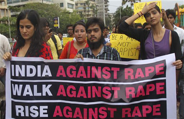 Bollywood actress Sonam Kapoor holds a banner as she participates a protest against the gang rape of a photojournalist in Mumbai, India, Sunday, Aug. 25, 2013. (AP Photo)