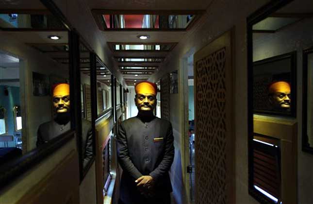 The Palace on Wheels is a luxury tourist train. It was launched by the Indian Railways to promote tourism in Rajasthan. An employee stands inside a cabin of the Palace on Wheels' train in New Delhi. (AP Photo)