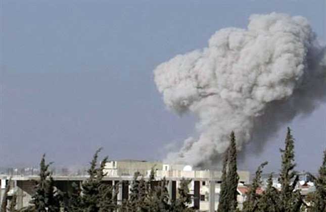 Smoke rises from buildings due to an air strike that hit Sarakeb, Idlib province, Syria. (AP Photo)