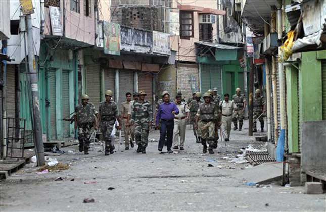 Officials and security forces patrol during an army enforced curfew imposed following deadly communal clashes in Muzaffarnagar, UP (AP Photo)