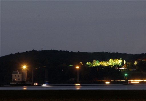 Night falls on the Hudson Valley and the Chelsea Clinton and Marc Mezvinsky wedding in Rhinebeck, N.Y., as seen from Port Ewen on Saturday, July 31, 2010. The Rondout lighthouse is at left. (AP Photo/Mike Groll)