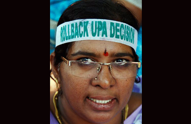 An Indian state government employee and supporter of United Andhra Pradesh shouts slogans during a hunger strike at the Andhra Pradesh Secretariat in Hyderabad, India, Tuesday, Oct. 8, 2013. Widespread power outages paralyzed life across the state after workers at state run and private power companies were shut by utility employees opposed to the federal government's decision to carve out a new state of Telangana comprising 10 districts of Andhra Pradesh. (AP Photo)