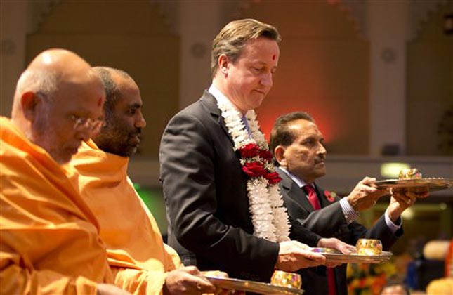 Britain's Prime Minister David Cameron, takes part in a ceremony at the Hindu temple Shri Swaminarayan Mandir in London, during Diwali. (AP Photo)