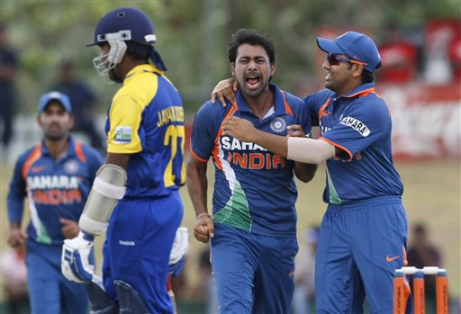 India's Praveen Kumar, second right, celebrates the dismissal of Sri Lankan batsman Mahela Jayawardene, second left, with teammate Rohit Sharma, right, during the one day international cricket match in the tri nation series in Dambulla, Sri Lanka, Monday, Aug. 16, 2010. (AP Photo/Eranga Jayawardena)