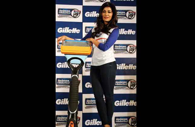 Bollywood actress Chitrangada Singh poses with a model of a shaving razor during its promotional event in Bangalore. (AP Photo)