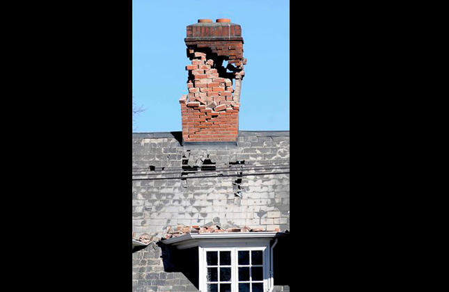 A damaged brick chimney sits atop a building in central Christchurch, New Zealand, Saturday, Sept. 4, 2010. A powerful 7.1 magnitude earthquake damaged buildings, cut power and knocked fleeing residents off their feet on New Zealand's South Island early Saturday, but there were so far no deaths and only two injuries reported. (AP Photo/NZPA, David Wethey)