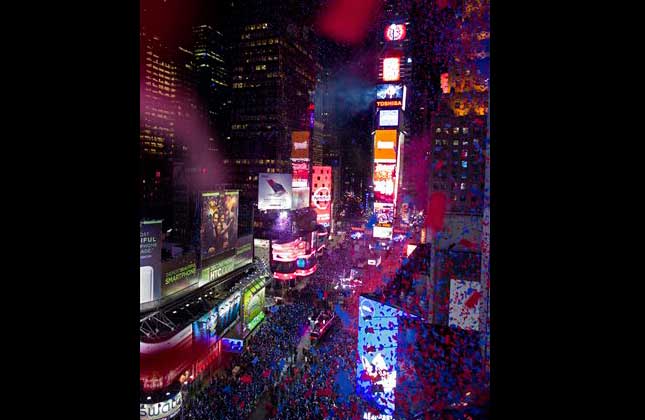 Seen from the Marriott Marquis, confetti flies over Times Square, released two hours before midnight, during New Year's Eve celebrations in New York. (AP Photo)